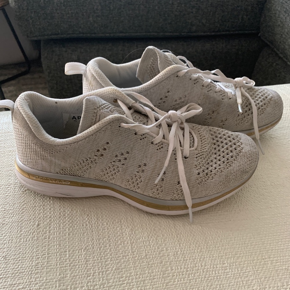 silver and gold APL sneakers